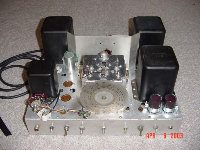 Figure 9 — The same view seventy years later, on a DX-100B stripped for restoration: modulation transformer at the centre, potted power transformers at the corners, the final's compartment with its perforated…