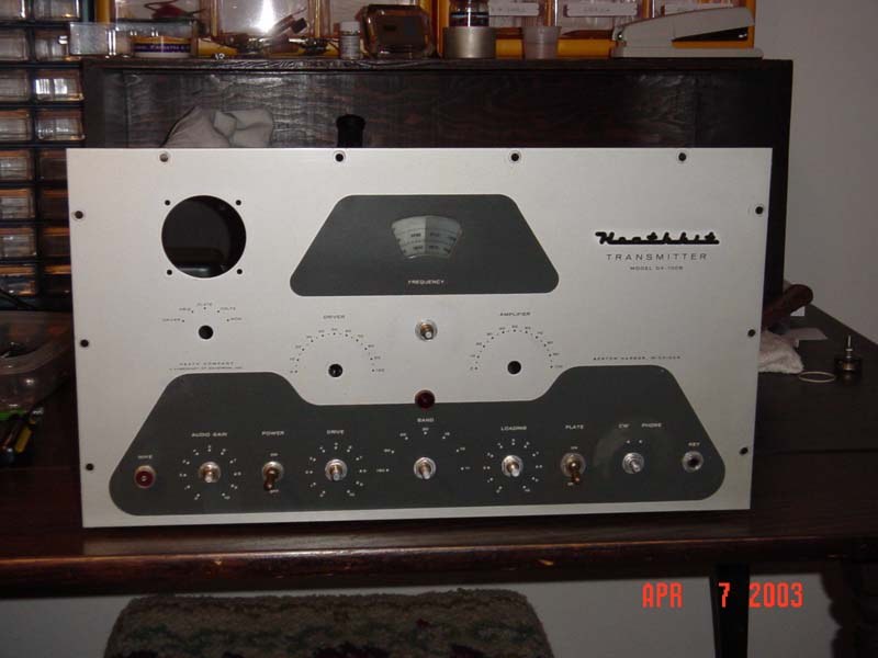 Figure 11 — A DX-100B during restoration with its front panel removed, showing the panel's pressed shape and the holes for meter, dial escutcheon and controls. On the original DX-100 this panel was part of a c…