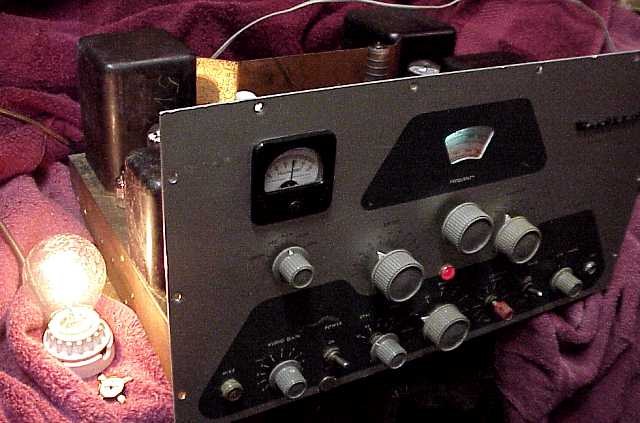 Figure 5 — The method still works: a restored DX-100 at full output into a 116-watt traffic-signal lamp used as a dummy load.