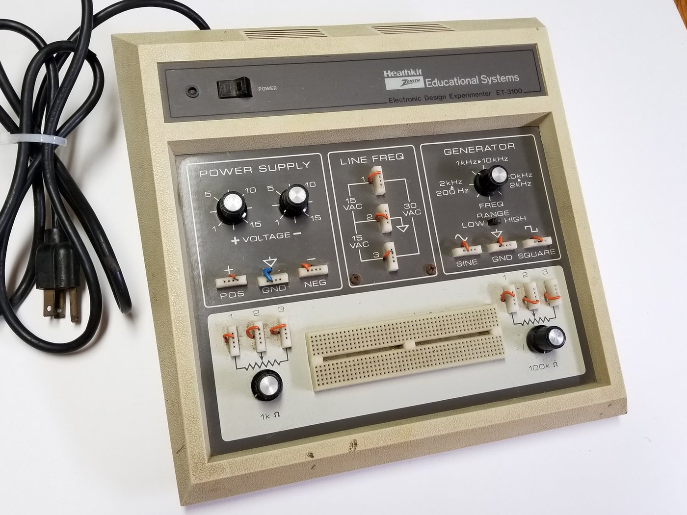 Figure 10 — A later-production ET-3100 in the beige Heathkit/Zenith Educational Systems cabinet, with the "Electronic Design Experimenter ET-3100" legend on the nameplate strip. The panel layout is unchanged f…