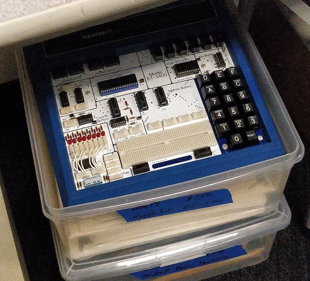 Figure 3 — An ET-3400 in its blue cabinet: keypad and six-digit display at right, the 6800 and memory in the centre, the eight LED indicators and eight DIP switches at lower left, and the breadboard and bus c…