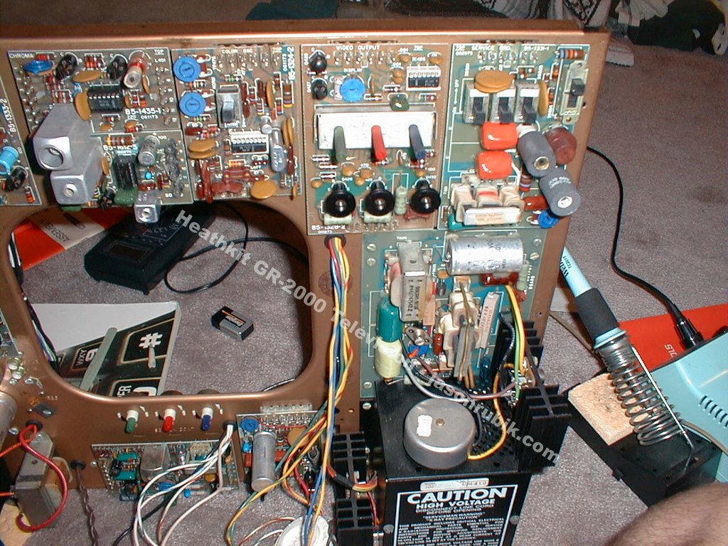 Figure 10 — The service area of a set under repair, with the chassis opened out and the boards accessible. Heath's slide-out drawer put the preset tuning controls, the readout board and the convergence board w…