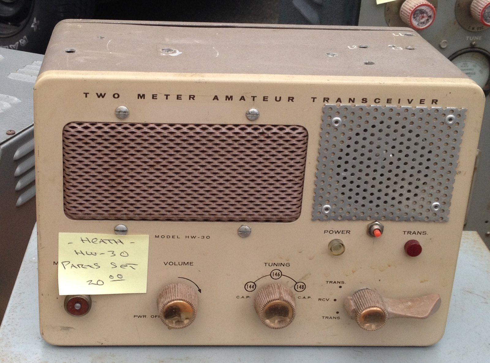 Figure 7 — An HW-30 "Twoer" two-metre transceiver at a flea market. Transmitter, super-regenerative receiver, power supply and speaker share one small cabinet; the microphone plugs into the front. The Twoer a…
