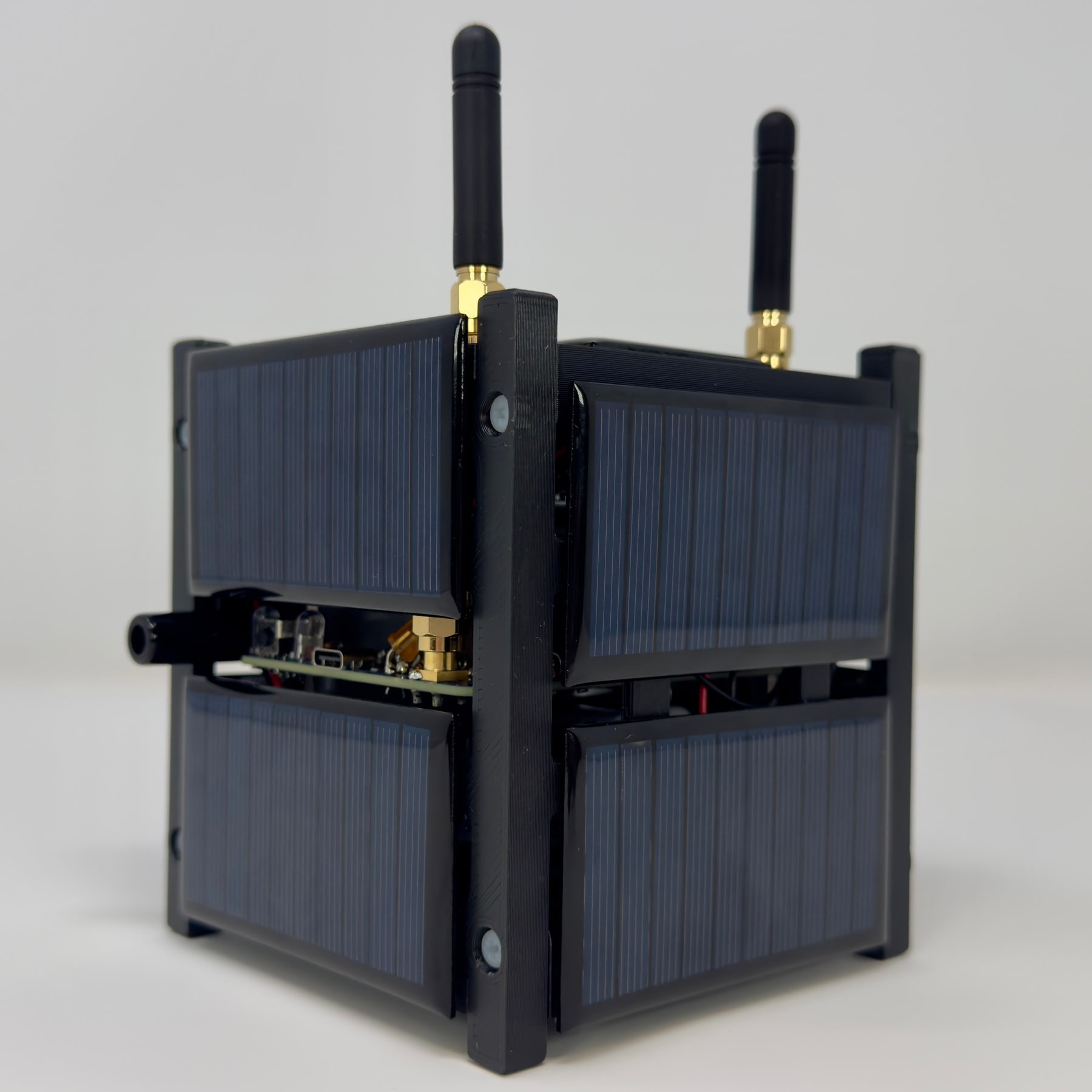 Figure 8 — The AMSAT CubeSatSim, Heathkit Edition (2025): a working CubeSat simulator sold as a classroom pack and bundled with a Kirkwall sensor-monitoring subscription. It is the first product of the Kirkwa…