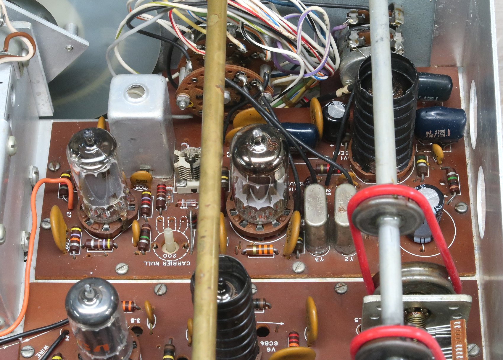 Figure 5 — The modulator circuit board in a restored set, with the carrier oscillator crystals in their cans and the balanced-modulator transformer T1 beside them. This board carries the numbering range 0–99 …