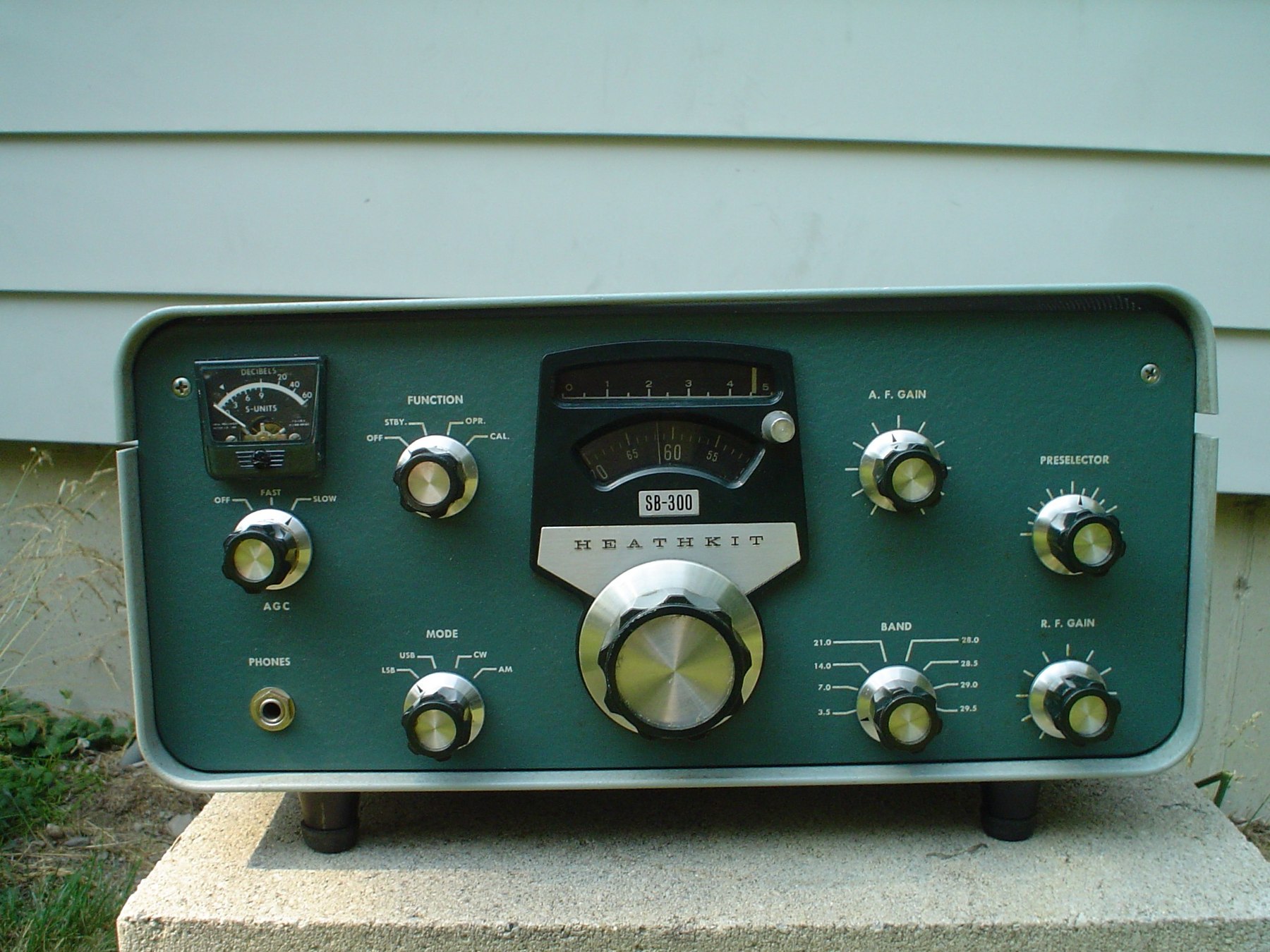 Figure 6 — A surviving SB-300. Compared with the SB-301 above: the FUNCTION switch and A.F. GAIN sit lower on the panel, the mode switch has no RTTY position, the band switch has no 15 MHz position, and there…
