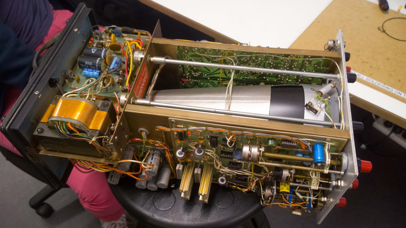 Figure 6 — The inside of an IO-4550 10 MHz dual-trace scope (1976–1984): the electrostatic CRT runs front to back down the middle, with the vertical and horizontal boards along the chassis and the high-voltag…