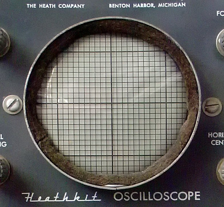 Figure 5 — The 3-inch screen and graticule of an OL-1 oscilloscope of 1954–56, with the "Heathkit Oscilloscope" script beneath. The OL-1 used a war-vintage 3GP1 tube, one of the parts that makes the older sco…